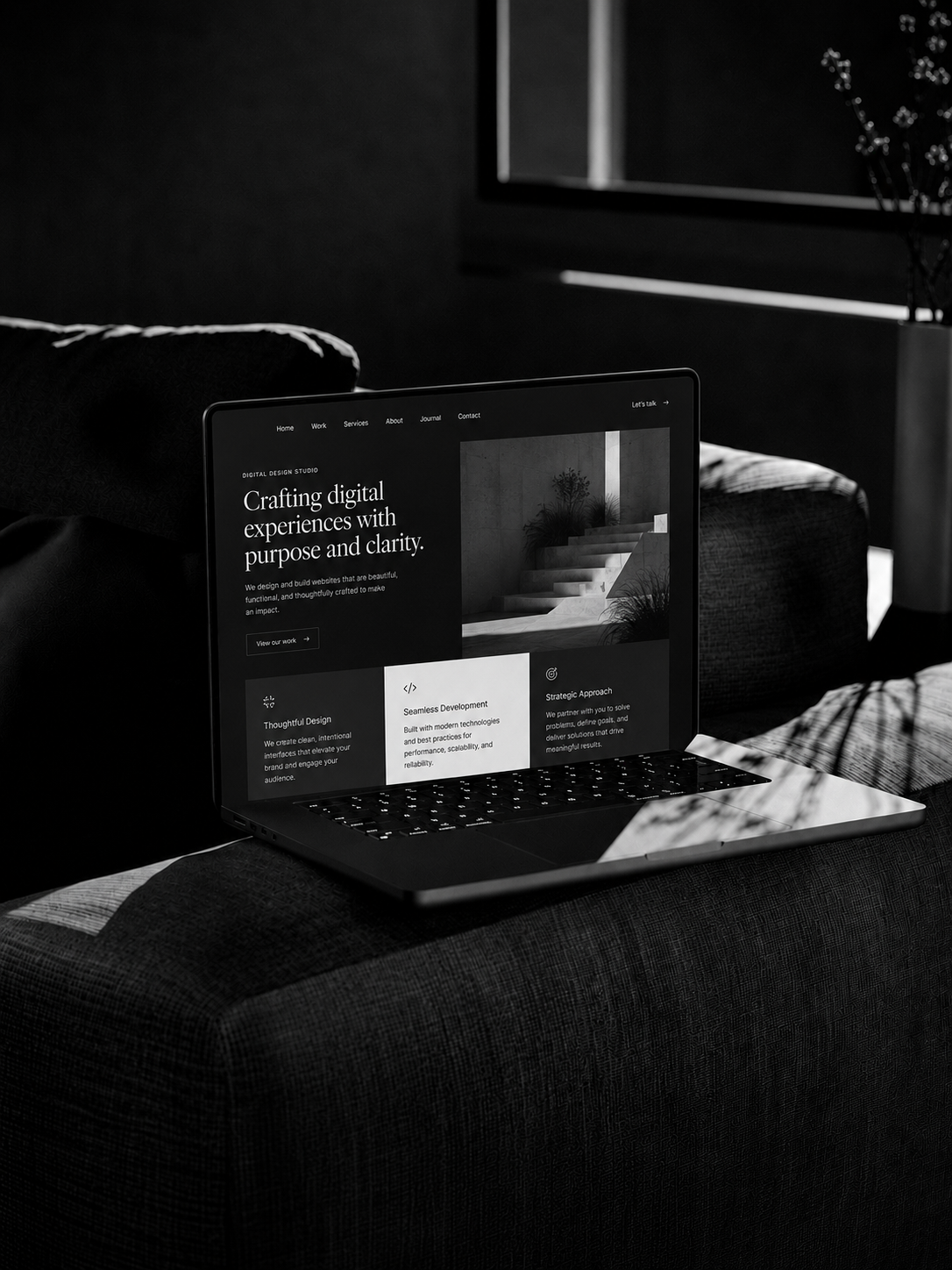 Editorial studio website shown on a laptop in a dark interior